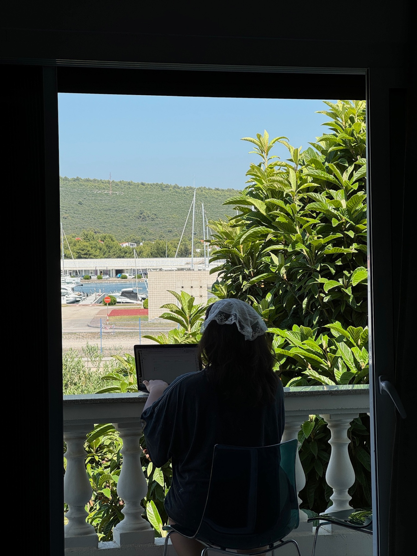 Sanya working remotely from a balcony in Croatia